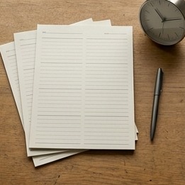 AI-generated editorial illustration: blank planning sheets beside clock and pen.