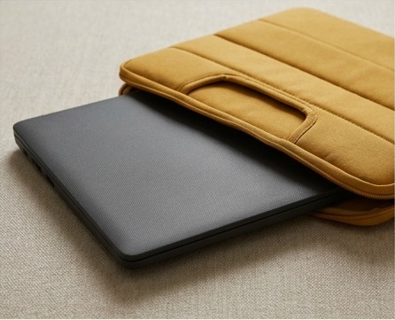 AI editorial photograph of closed laptop beside protective sleeve