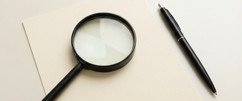 AI editorial illustration of a magnifying glass over blank paper