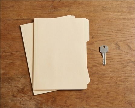 AI editorial photograph of plain staging folders and security key