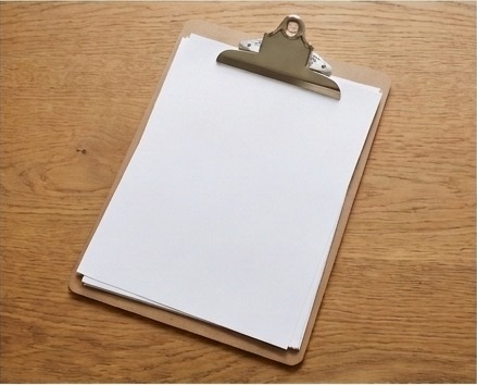 AI-generated editorial illustration of blank teaching sheets on clipboard