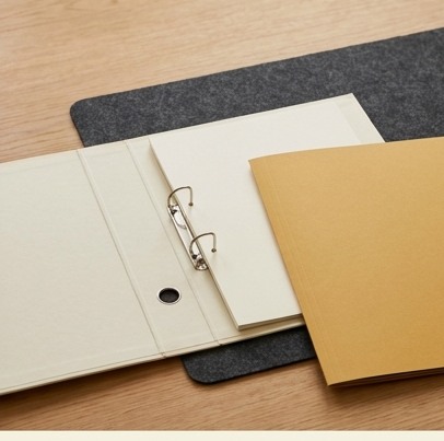 AI-generated editorial illustration: open binder beside mustard folder.