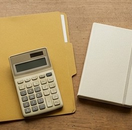 AI-generated editorial illustration: mustard folder, calculator and cream notebook.