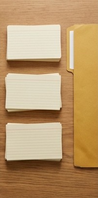 AI-generated editorial illustration: separate stacks of blank cream cards.