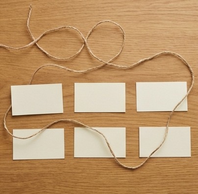 AI-generated editorial illustration: blank cards connected by loose cord.
